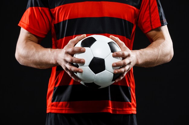 Cropped shot of goalkeeper hands with football