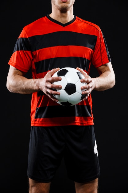 Free photo cropped shot of goalkeeper hands with football