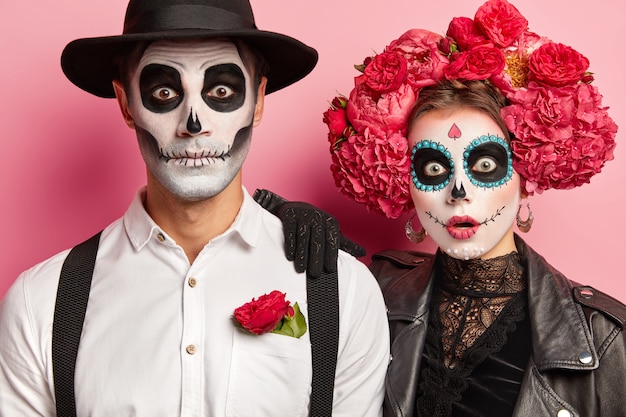 Cropped shot of shocked terrified woman and man wear vampire costumes