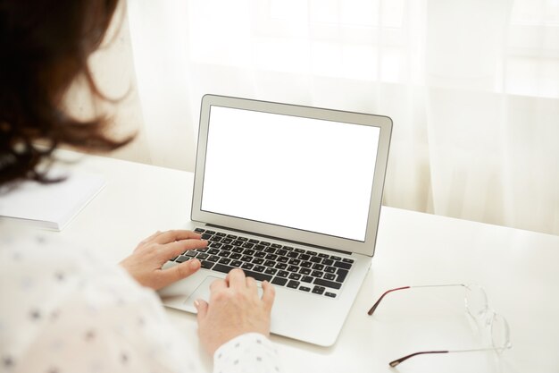 Free Photo cropped shot view of young smart mature female businesswomen working online via laptop