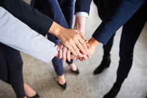 Free photo cropped shot of women putting hands together in circle