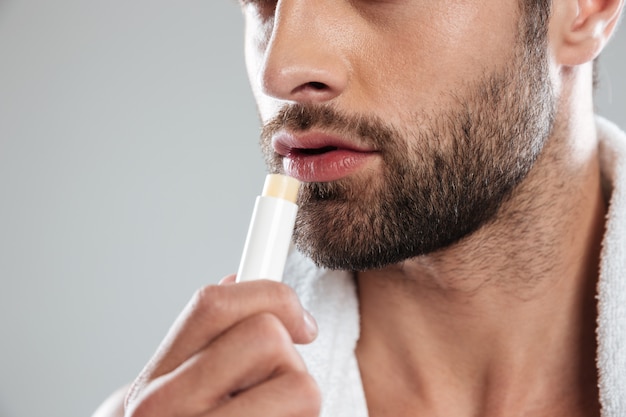 Cropped shot of young man with сolorless lipstick