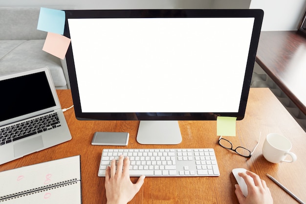 Cropped top shot of female hands typing on the keyboard, sitting in the office