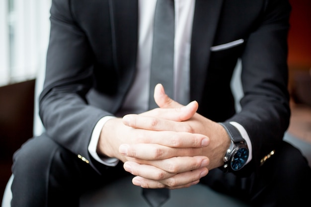 Cropped View of Businessman Clasped Hands