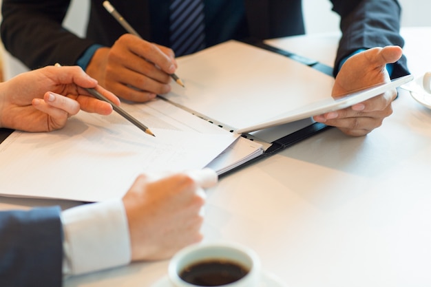 Cropped View of Colleagues Working With Documents