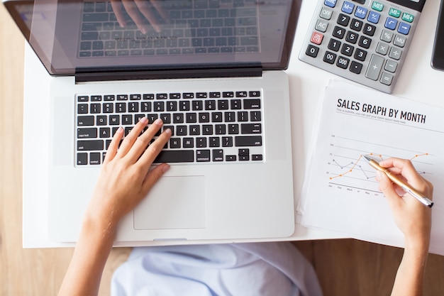 Cropped View of Female Manager Studying Graph