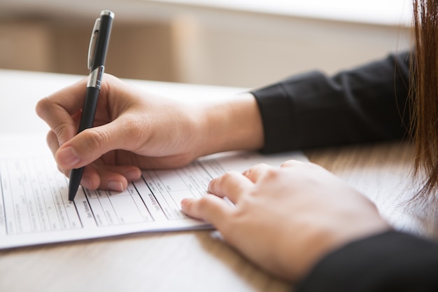 Cropped View of Woman Filling in Application Form