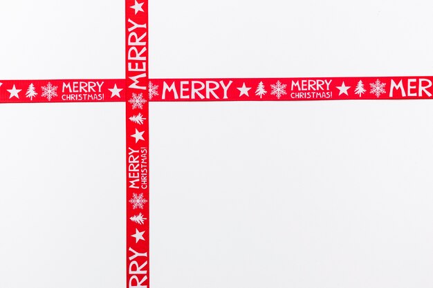 Crossed red ribbons saying Merry Christmas