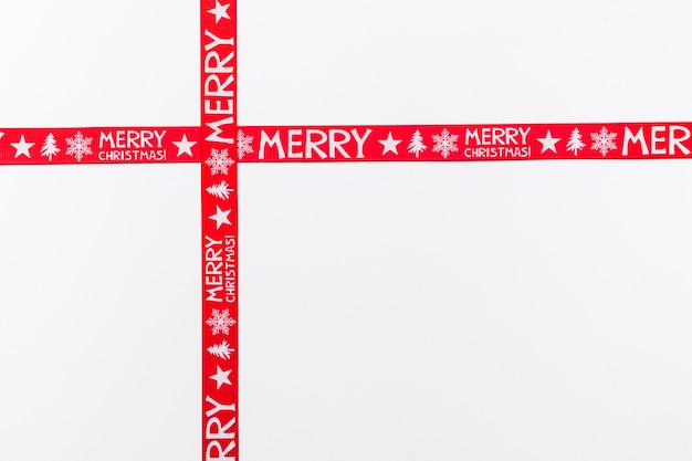 Crossed red ribbons saying Merry Christmas