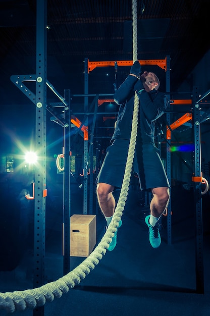 Crossfit athlete with a rope during workout at the gym