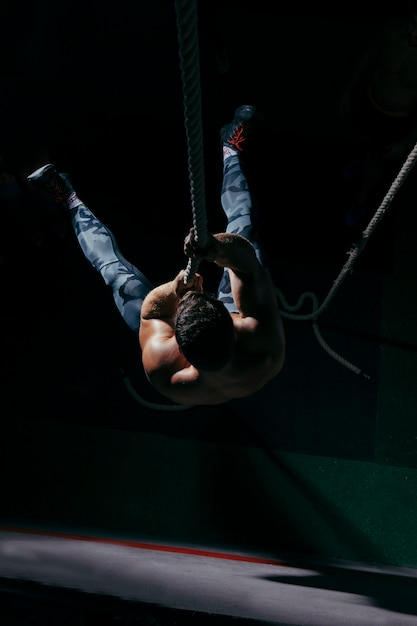 Free photo crossfit concept with man training on rope