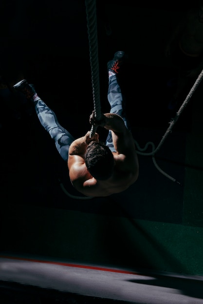 Crossfit concept with man training on rope