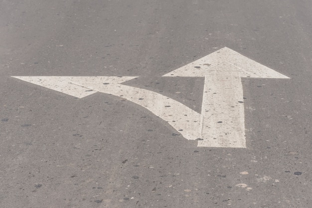 Crossroad arrow lines on asphalt