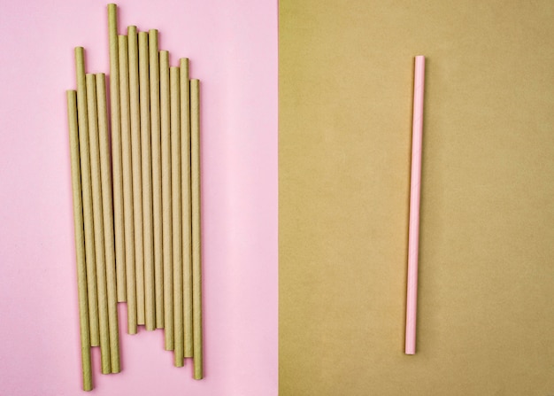 Crowd of brown straws and pink straw