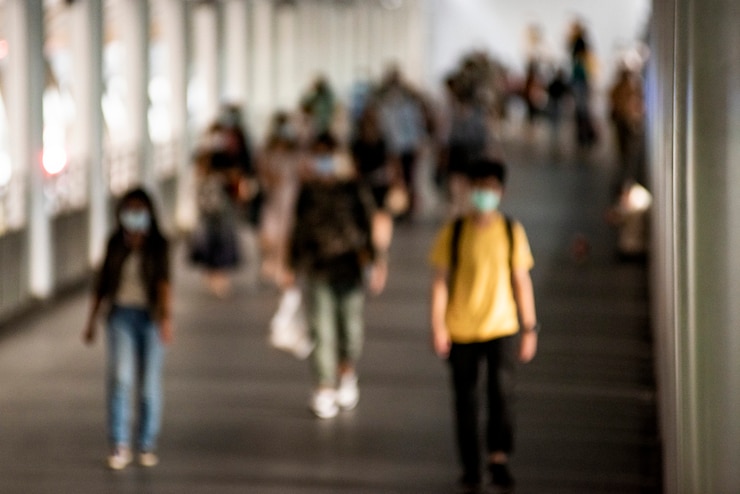 Free Photo crowd of people wearing mask walking in the new normal