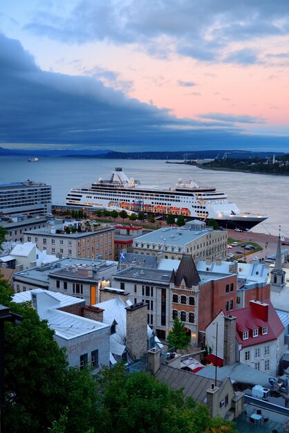 Cruise ship and lower town old buildings at sunset in Quebec City.