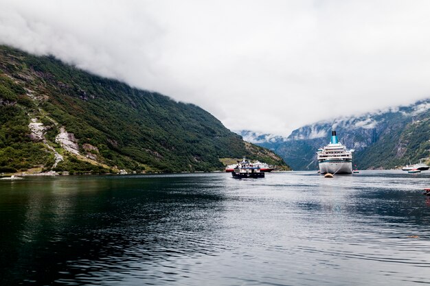 Cruise ship on sea with mountains