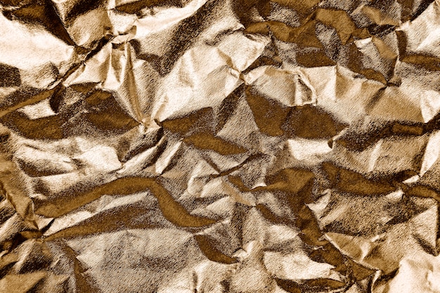 Free photo crumpled gold paper textured background