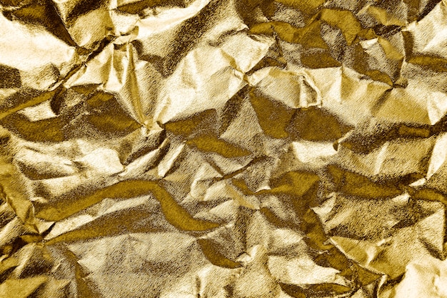 Crumpled gold paper textured background