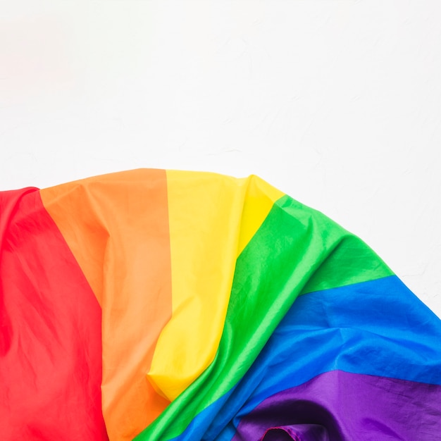 Crumpled LGBT flag on white surface