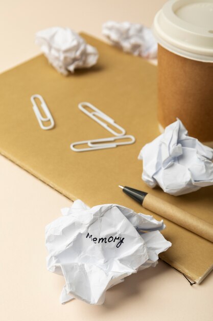 Crumpled paper and cup high angle