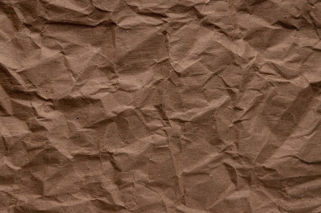 Crumpled paper. sheet of brown cardboard paper. detailed high resolution texture. abstract background for wallpaper.