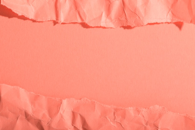 Crumpled paper texture on coral background