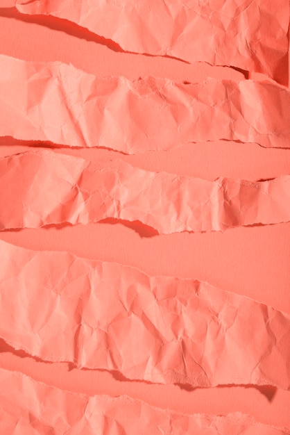 Crumpled paper texture on coral background