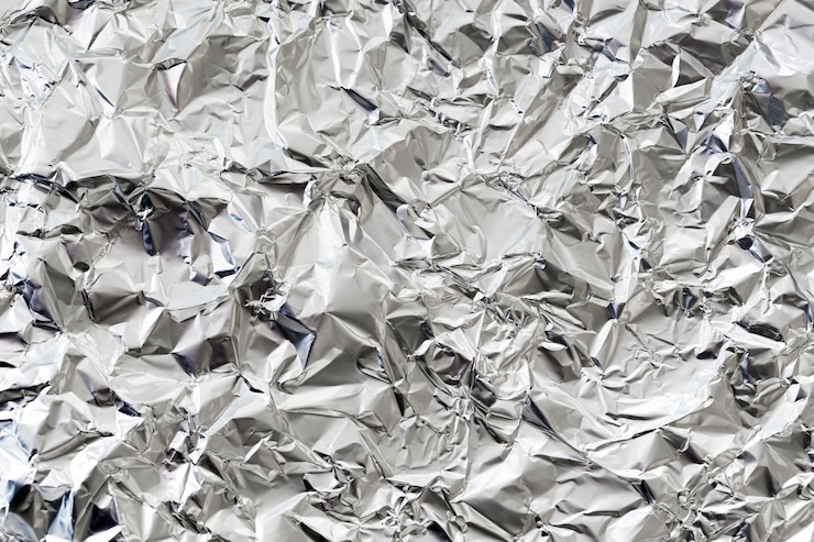 Free Photo crumpled silver aluminium foil background