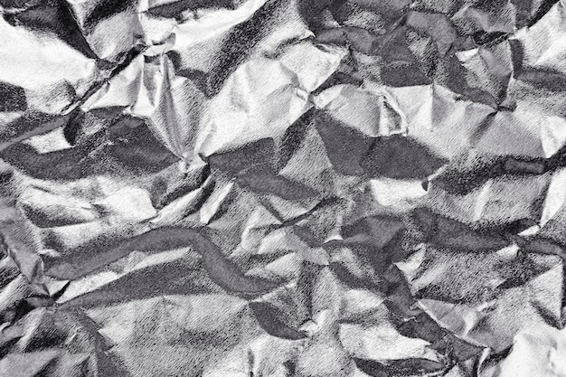 Free photo crumpled silver paper textured background