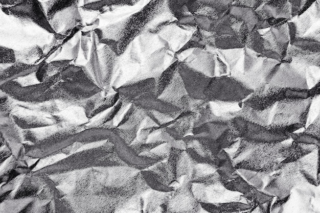 Crumpled silver paper textured background