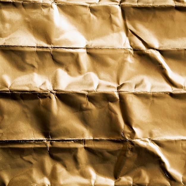 Free photo crumpled squared of gold top view