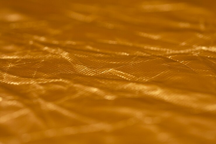 Free Photo crumpled up golden foil background