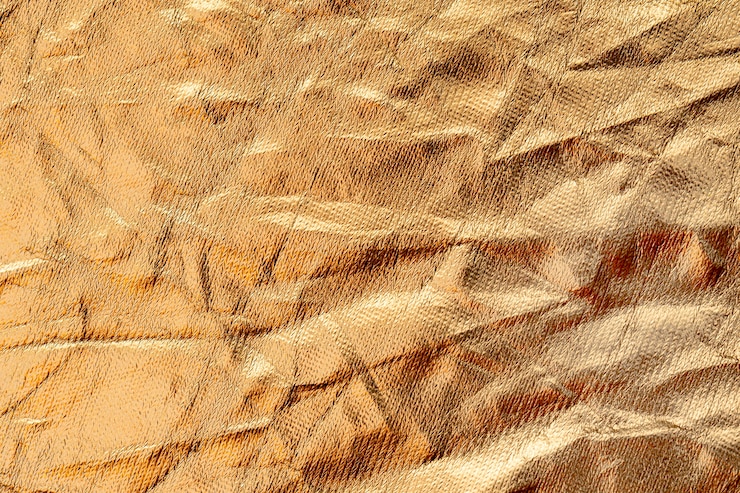 Free Photo crumpled up golden foil background