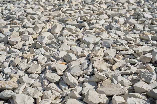 Crushed and split stone closeup selective focus Construction rubble background to describe construction or stone mining