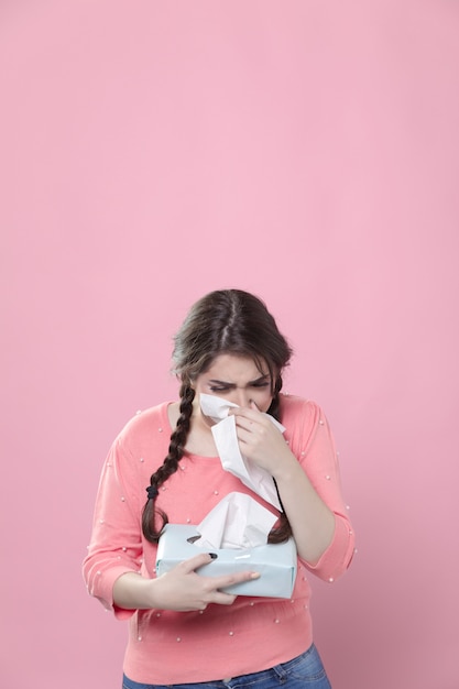 Free photo crying woman blowing her nose in napkins