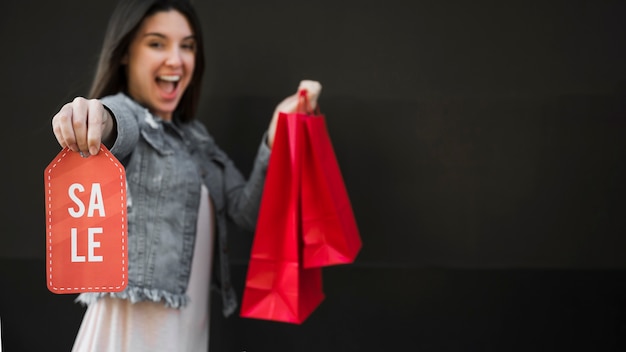 Crying woman with shopping packets and sale tablet