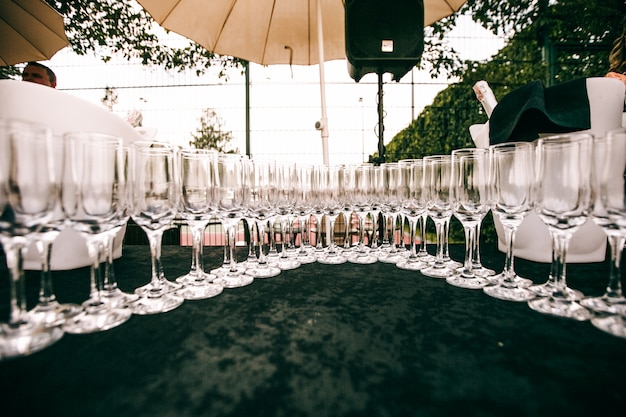 Crystal champagne flutes stand on a table 