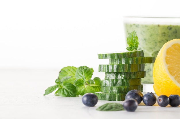 Cucumber slices in front of smoothie