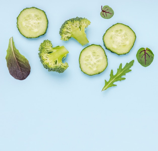 Cucumber slices with broccoli and salad leaves