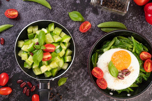 Cucumber stir-fried with tomatoes and red beans in a frying pan.