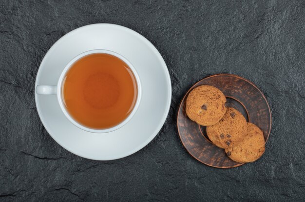 A cup of aroma tea with delicious cookies.