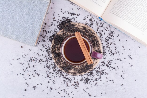 Cup of black tea with cinnamon stick and dry tea. High quality photo