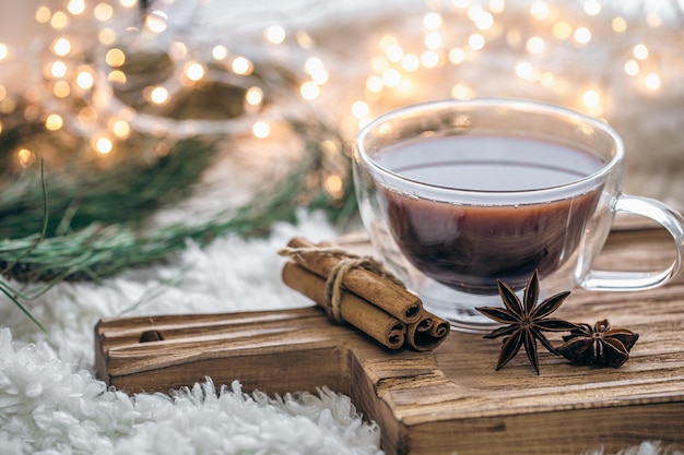 A cup of cocoa cinnamon and star anise on a blurred background with bokeh