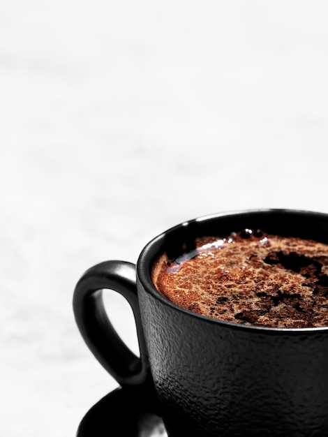 Cup of coffee of aromatic espresso on a light gray surface