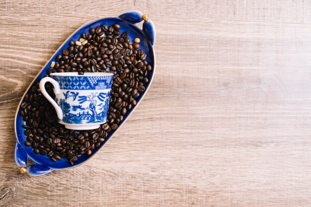 Cup on coffee beans