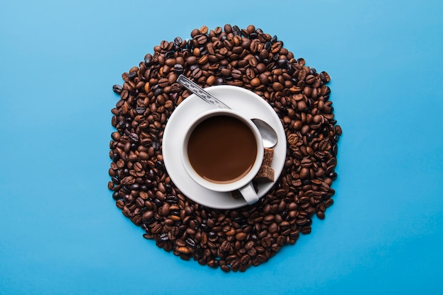 Cup on coffee beans