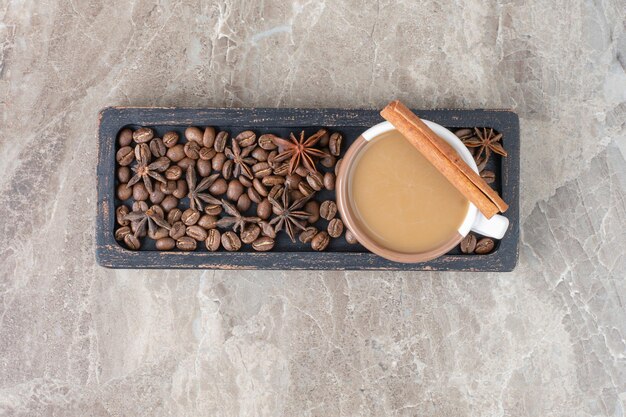 Cup of coffee and coffee beans on dark plate. High quality photo