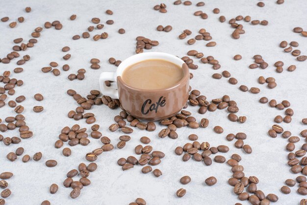 Cup of coffee and coffee beans on marble background. high quality photo