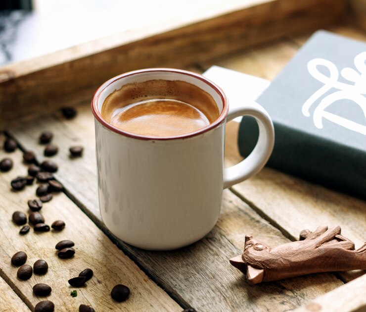 Free Photo a cup of coffee and coffee beans